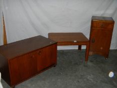 A sliding door cabinet on wheels, a 1930's bedside cabinet and a G plan table.