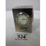 A small three sided clock/thermometer/hydrometer, 7 cm tall.
