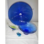 A 40 cm diameter blue glass bowl and other blue glass ware.