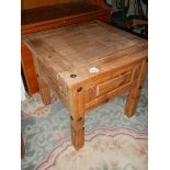 A small rustic pine coffee table.