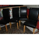 A set of 4 leather dining chairs in good condition.