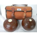 A cased pair of vintage lawn bowls.