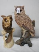 A tall long eared owl (36 cm) and a smaller carved owl.