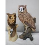 A tall long eared owl (36 cm) and a smaller carved owl.