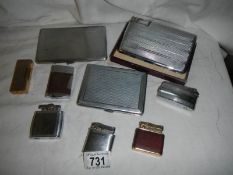 A mixed lot of cigarette lighters and cases.