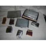 A mixed lot of cigarette lighters and cases.