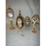 4 decorative collector's eggs in various materials.