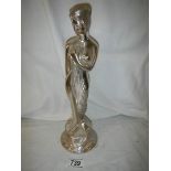 A metal figure of a lady, 32 cm tall.