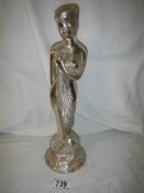 A metal figure of a lady, 32 cm tall.