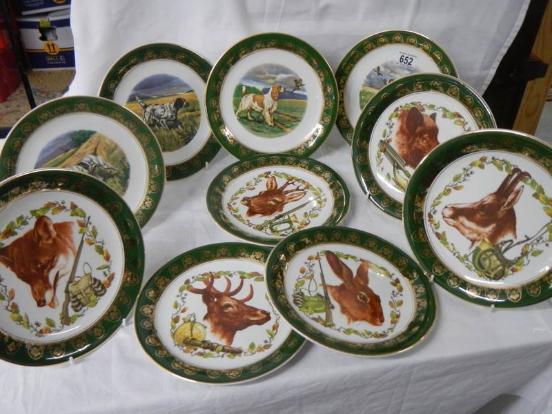 Ten collector's plates depicting dogs and other animals.