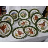 Ten collector's plates depicting dogs and other animals.