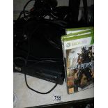 An Xbox 360 with extra controller, games and guitar.