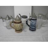 Three glass beer steins and 2 Avon pottery beer steins.