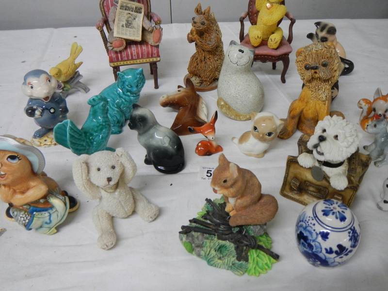 Approximately 24 assorted china animals etc., including dogs, bears on chairs etc.