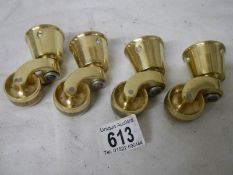 A set of 4 new brass table casters, internal diameter of cup 3.5 cm.