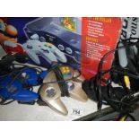 A boxed Nintendo 64 with all contents, 3 extra controllers and a Sega Megadrive control.