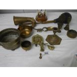 A mixed lot of old brassware, horn works but brass is cracked, also a modern clock.