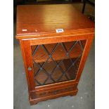 A lead glazed single door cabinet.