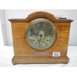 A mahogany mantel clock with key (springs ok).