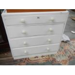 A 4 drawer white painted chest.