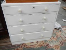 A 4 drawer white painted chest.