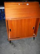 A mahogany sliding door bureau.