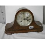 A mahogany mantel clock in working order.