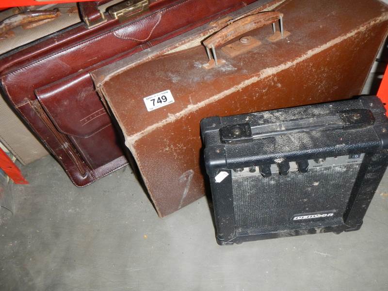 A small vintage suitcases a leather briefcase & an amplifier