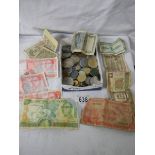 A mixed lot of old coins and bank notes.