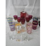 2 good sets of coloured glasses, a cranberry glass lidded jar, an etched decanter and 2 glasses.