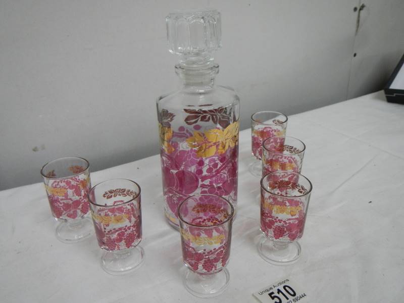 A mid 20th century boxed decanter and glass set decorated with red and gold transfers. - Image 2 of 4