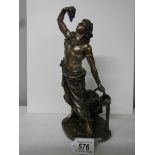 A bronzed figure of a male leaning against a large water urn in excellent condition, 27 cm tall.