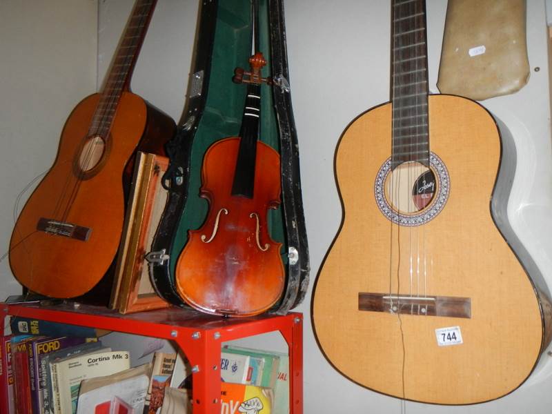 A Dulcet classical guitar, an 'El Primo' guitar, a practice amp and a Lark cased violin.