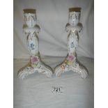 A pair of continental porcelain candlesticks, in good condition.