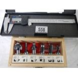 An electronic digital calliper and a set of 6 new router bits.