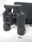 A cased pair of 7 x 50 binoculars with lens covers and fitted compass.