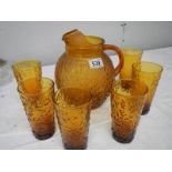 An amber coloured mid 20th century glass lemonade set.