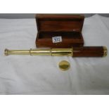 A 3 draw brass telescope in wooden case with brass plaque reading Towe of London,