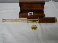 A 3 draw brass telescope in wooden case with brass plaque reading Towe of London,