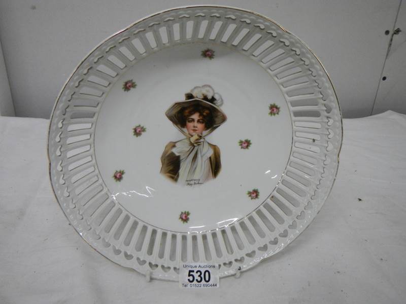 A hand painted and signed dish, 26cm diameter, in good condition.