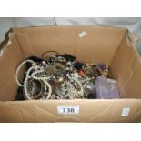 A large lot of unsorted costume jewellery.