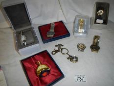 A quantity of ladies and gents wrist watches, miniature ball clock etc.