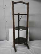 An oak 20th century folding cake stand, in good condition.