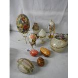 A mixed lot of decorative collector's eggs in china and other materials.