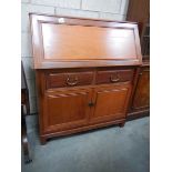 A teak bureau with 2 drawers and 2 cupboards.