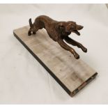 Art Deco bronze figure of a leaping hunter Dog, on a stepped base of beige above black/brown, 36cm w