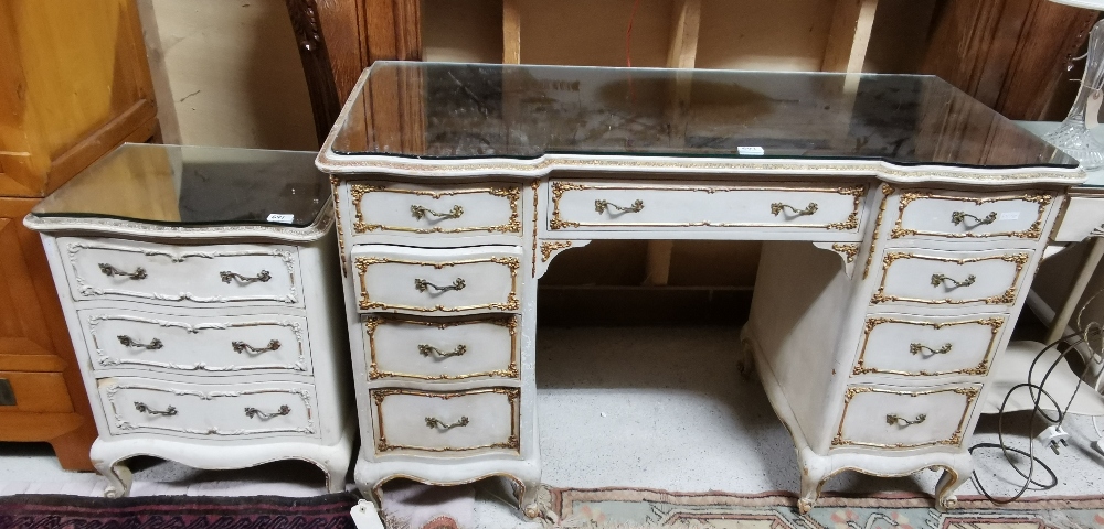 A French style painted & parcel gilded kneehole Dressing Table with a mirrored glass top, 123cm