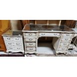 A French style painted & parcel gilded kneehole Dressing Table with a mirrored glass top, 123cm