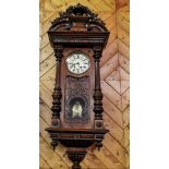 Large Carved Mahogany Cased Wall Clock, Spring Driven, with a decorative pediment, reeded side