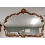 Wall Mirror, in a shaped gold painted resin frame, shell to the pediment, 90cmH x 116cmW